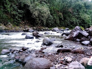 photo of a river with lots of large rocks in Doro village, Pekalongan