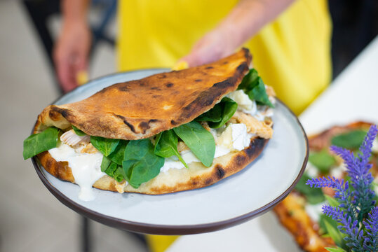 Opened opne calzone italian pizza with cheese in plate homemade in Lithuania