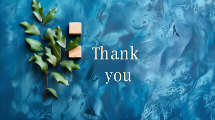 Thank you symbol. Wooden blocks with words "Thank you" with italis font. Beautiful blue background. Business and Thank you concept. Copy space.