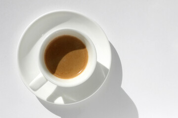 Freshly Brewed Espresso in White Ceramic Cup Isolated on White Background. Cafe.	