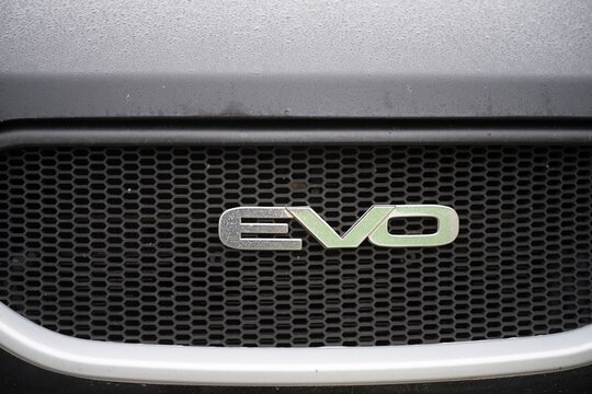 Close-up of evo logo on a black mitsubishi lancer evolution x front grille