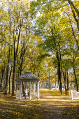 A park with a gazebo and trees in the background