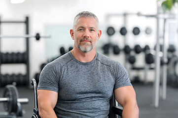 confident man in a wheelchair at a gym, wearing athletic gear, representing strength, inclusivity, determination, and fitness for adaptive training and motivational themes