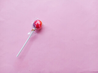 a lollipop on a pink background. Colorful lollipops, sweet and attractive taste. sweet round candy