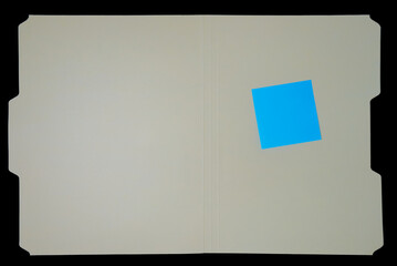 manila file folder with sticky note on black background