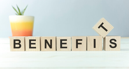 benefits word written on wood block on a light background