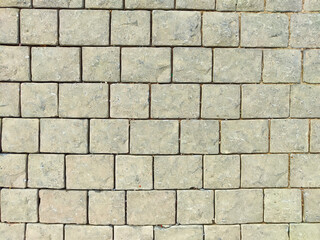 Gray textured paving stones arranged neatly on the ground for landscaping in an outdoor setting...