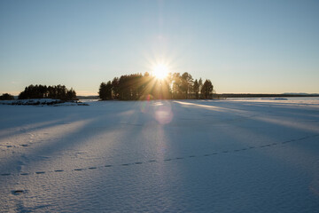 Snow-covered landscape in Leksand, Dalarna, illuminated by winter sun