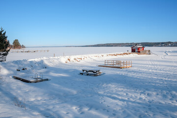 Winter landscape of snow-covered Västanvik in Dalarna, Sweden showcasing serene lakefront