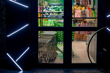 working grocery supermarket through the front door in the evening