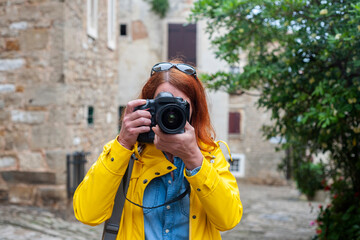 A female photographer takes pictures while visiting interesting tourist destinations