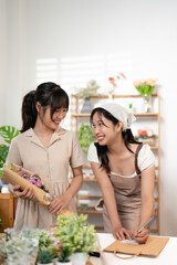 Asia people young woman SME owner happy smile enjoy open flower shop work at home office workspace. Loan money banking for online store seller. Girl power pride in sale order.