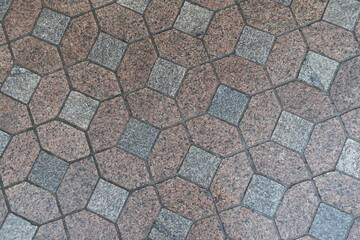 wet red and grey unpolished granite pavement texture