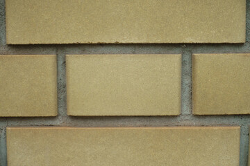 Macro of pale yellow smooth brick wall with English bond