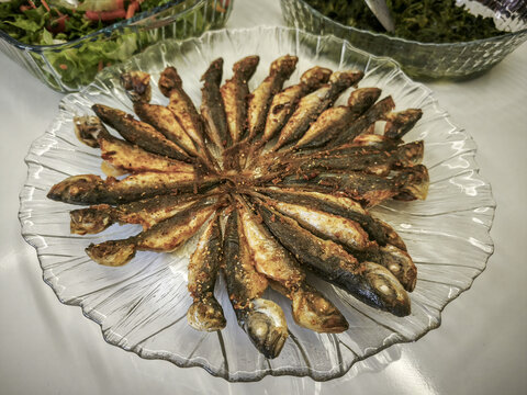 Cooked horse mackerel fish in a plate on the table