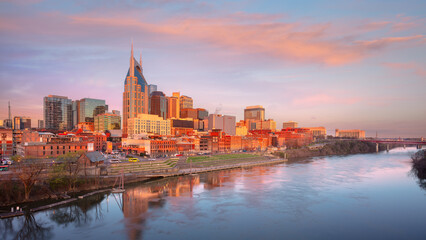 Nashville, Tennessee, USA. Cityscape image of Nashville, Tennessee, USA downtown skyline with reflection of the city the Cumberland River at spring sunrise.