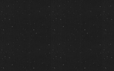 Fototapeta premium A black background with speckled patterns, creating a bold and modern texture ideal for edgy and creative designs.