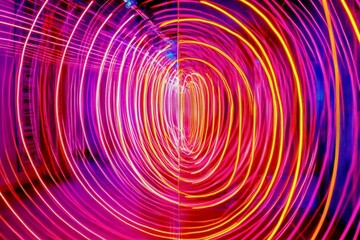 Dynamic, overlapping arcs of neon pink, orange, and yellow, radiating playful energy