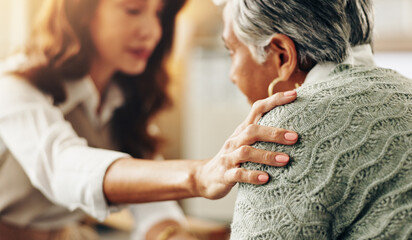 Therapist, woman and hand on shoulder for support, counseling and empathy for trauma in office....
