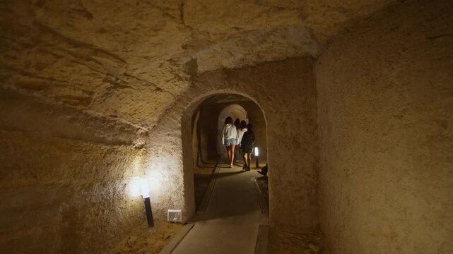 The caves of Camerano (also called "underground city of Camerano") with tourists from behind during a guided tour