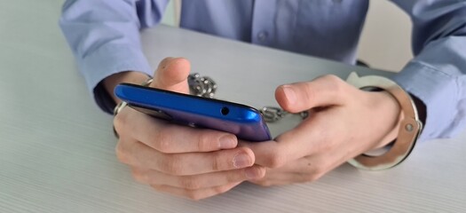 Teenager is handcuffed with phone and addicted to using phones and smartphones.