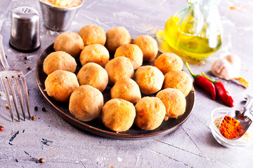 Fresh falafel balls on a black plate