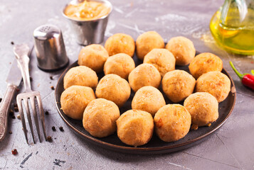 Fresh falafel balls on a black plate