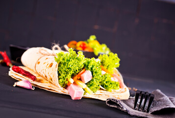 Shawarma sandwich, fresh roll of lavash (pita bread) pork shawarma with ham and cheese