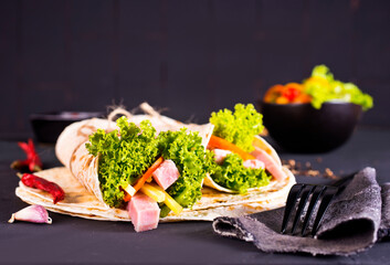 Shawarma sandwich, fresh roll of lavash (pita bread) pork shawarma with ham and cheese