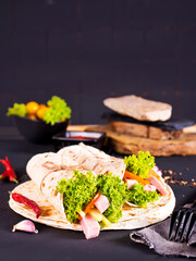 Shawarma sandwich, fresh roll of lavash (pita bread) pork shawarma with ham and cheese