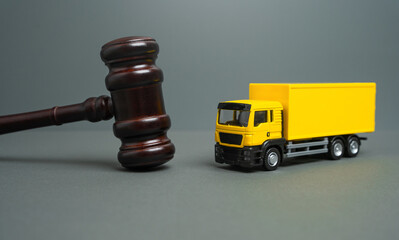 Yellow truck and judge's gavel. Court case. New laws and acts. Restrictions and regulations....