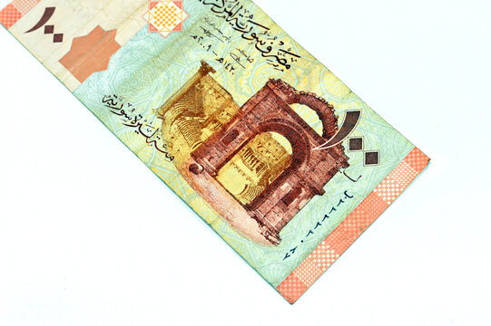 Syrian one hundred pounds issued by central bank of Syria 2009, features Bab el-Hawa or Gate of the wind, the Western Gate built from black basalt stone and The Bosra Amphitheatre