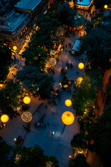 Obraz premium Aerial view of a bustling city square at night, with festive lights and vibrant decorations creating a magical and warm atmosphere at a christmas market