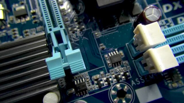 An electronic board with SMD components, parts, memory slots, a large chip and a radiator for cooling it