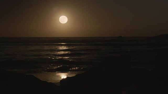 Strawberry Moon - rare event of the special solstice Full Moon in June 2024. Beautiful lunar path on the calm