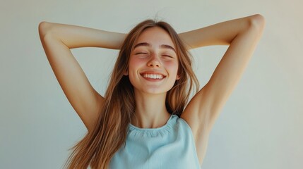 Fototapeta premium Joyful young woman stretching with a radiant smile against a light background