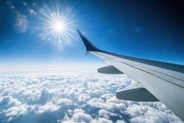 Fototapeta premium Breathtaking airplane wing view from a passenger seat above the clouds in bright blue sky capturing the essence of travel and adventure in the open sky