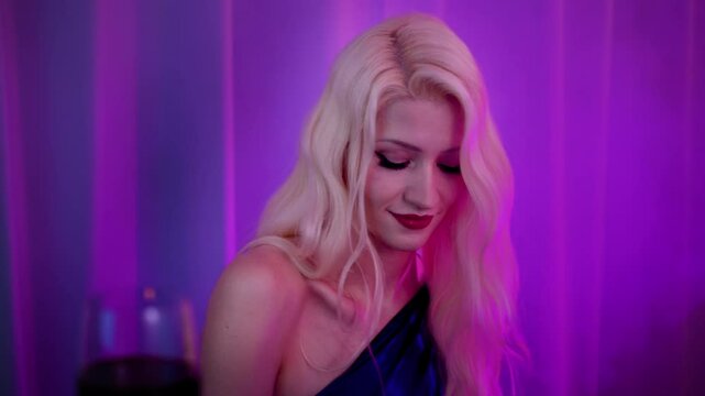 Attractive Blond Pianist Woman Playing Piano at Lounge Lit with Dim Purple Lights and Smoke in the Air