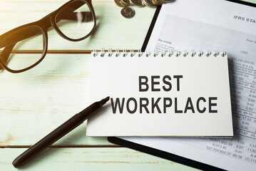 Notebook with the inscription BEST WORKPLACE, business concept image with soft focus background.