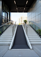 Obraz premium Accessible ramp and stairs at modern building entrance