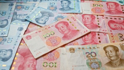 Chinese yuan banknotes spread out showcasing various denominations of currency from china in close...