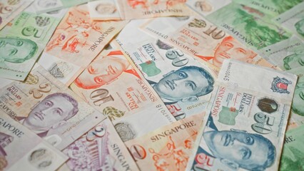 Obraz premium Singapore dollars banknotes in various denominations spread out in a vibrant display, showcasing the colorful currency of singapore and its intricate design elements.