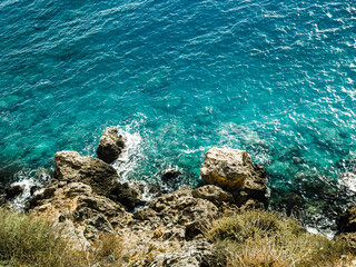 Top view of the sea, amazing nature background. The color of the water and beautifully bright. Azure beach with rocky mountains and clear water Aegean sea on a sunny day. Landscape background