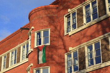 Naklejka premium Amsterdam Admiralengracht Red Brick House Facade with Palestinian Flag, Netherlands