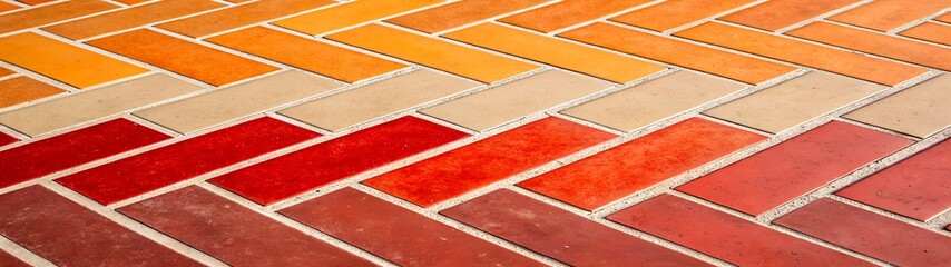 Fototapeta premium Abstract geometric brick pattern with colorful gradient hues, suitable for architectural or creative design projects