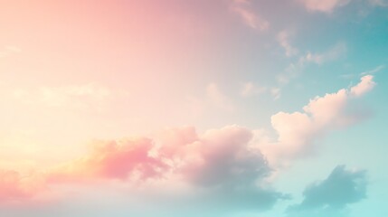 Fototapeta premium A soft, dreamy, and colorful sky with pink and yellow hues at sunset.