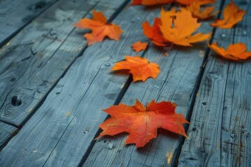 Obraz premium Autumn Maple Leaves on Weathered Wooden Surface