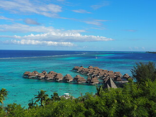 Overwater bungalows in a tropical lagoon with clear turquoise water and peaceful scenic views. © marta
