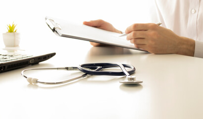online medical consultation - doctor working on laptop computer in clinic office. copy space