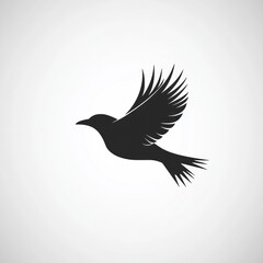 Obraz premium Simple black silhouette of a bird in flight.